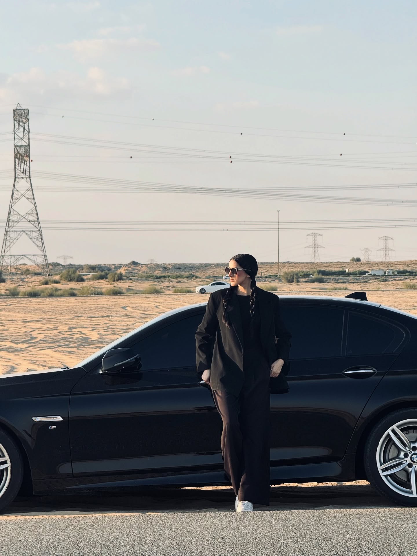 Leaning on BMW in the desert