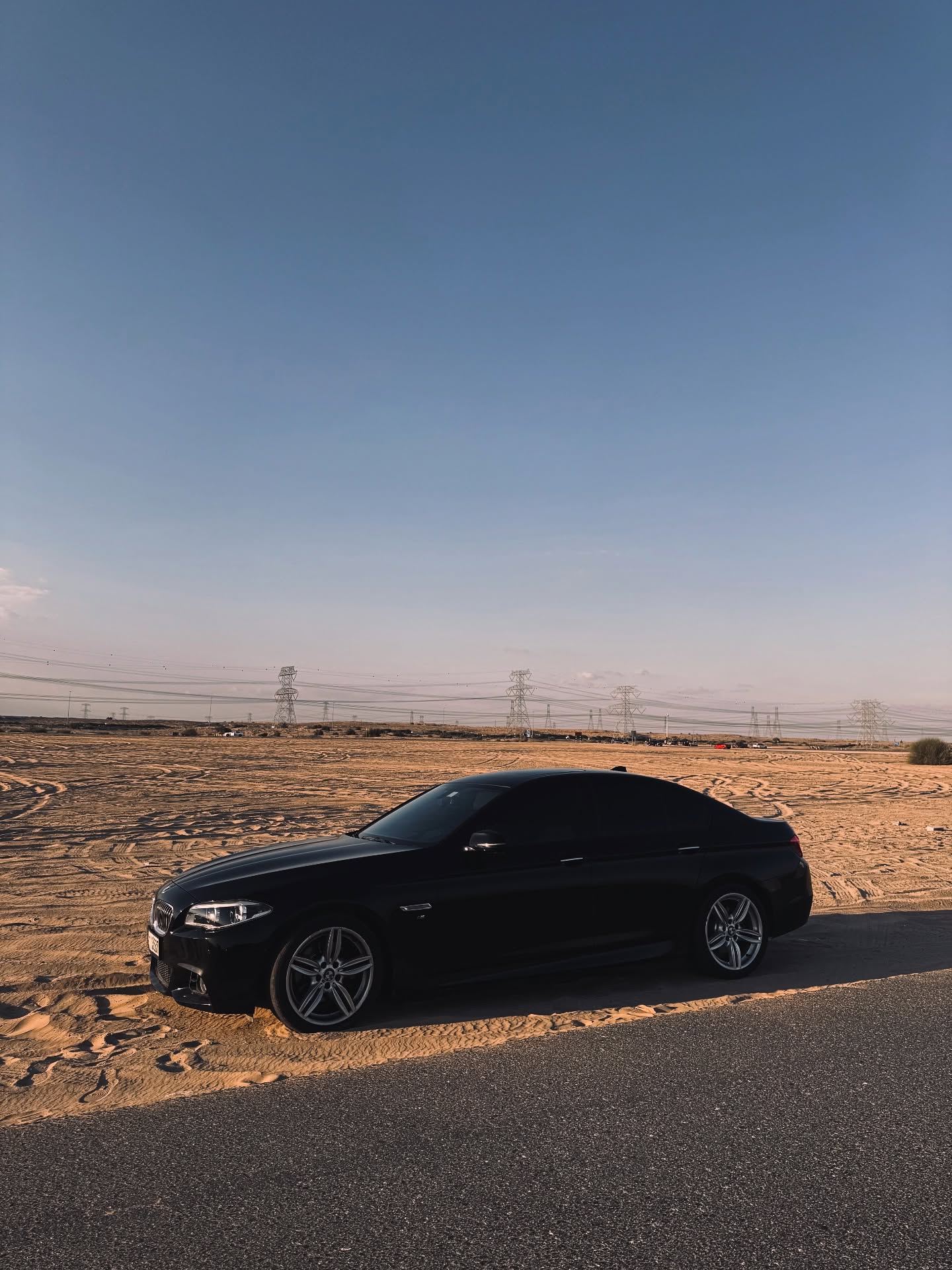 BMW parked on desert sand