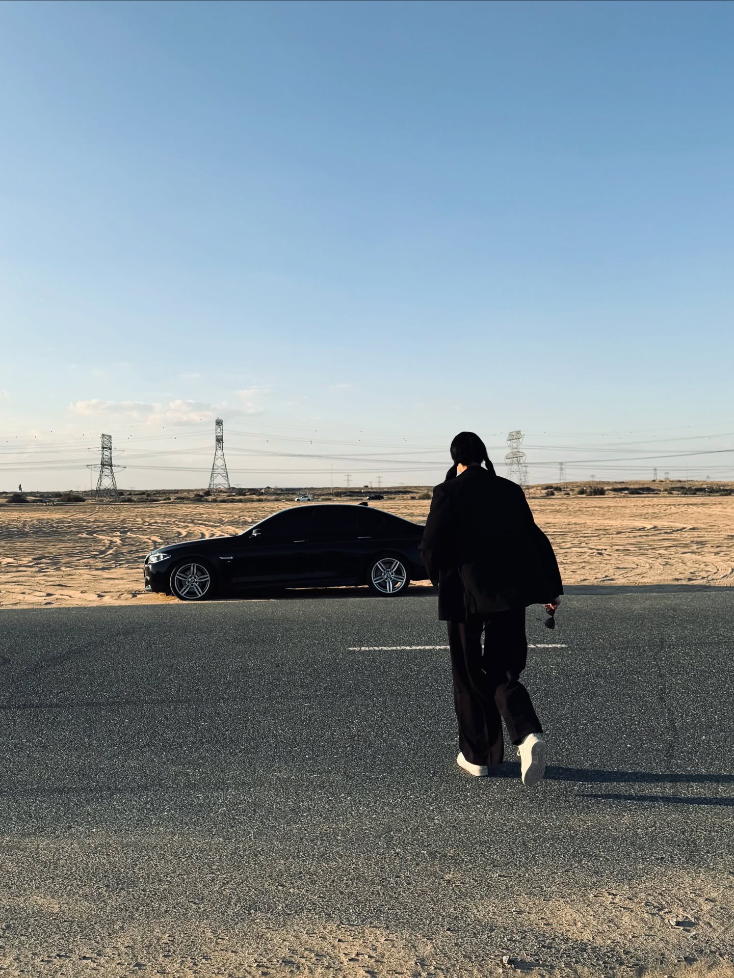 Walking toward the BMW on a desert road